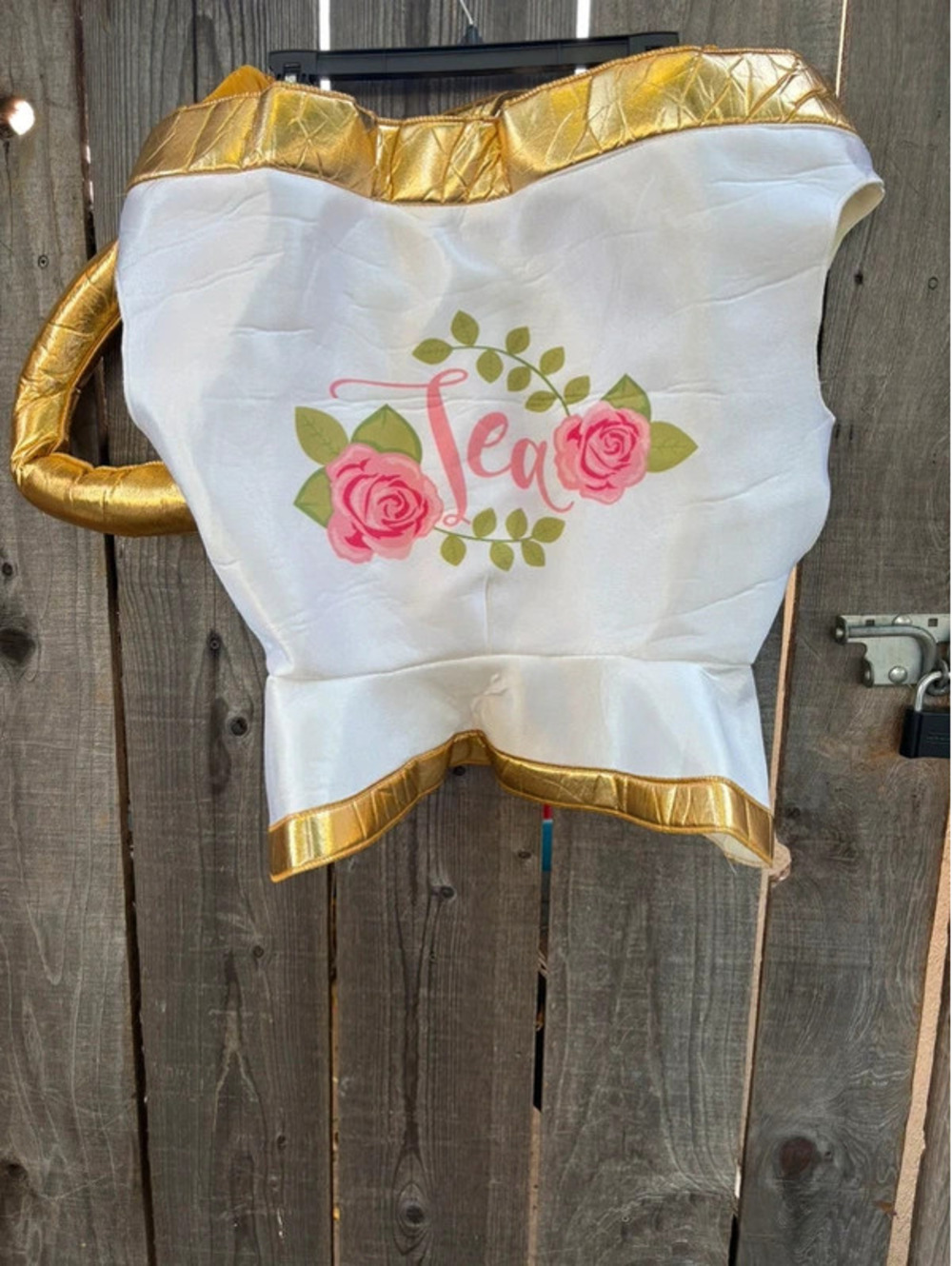 teacup costume handle on the side and a "Tea" graphic surrounded by pink roses.